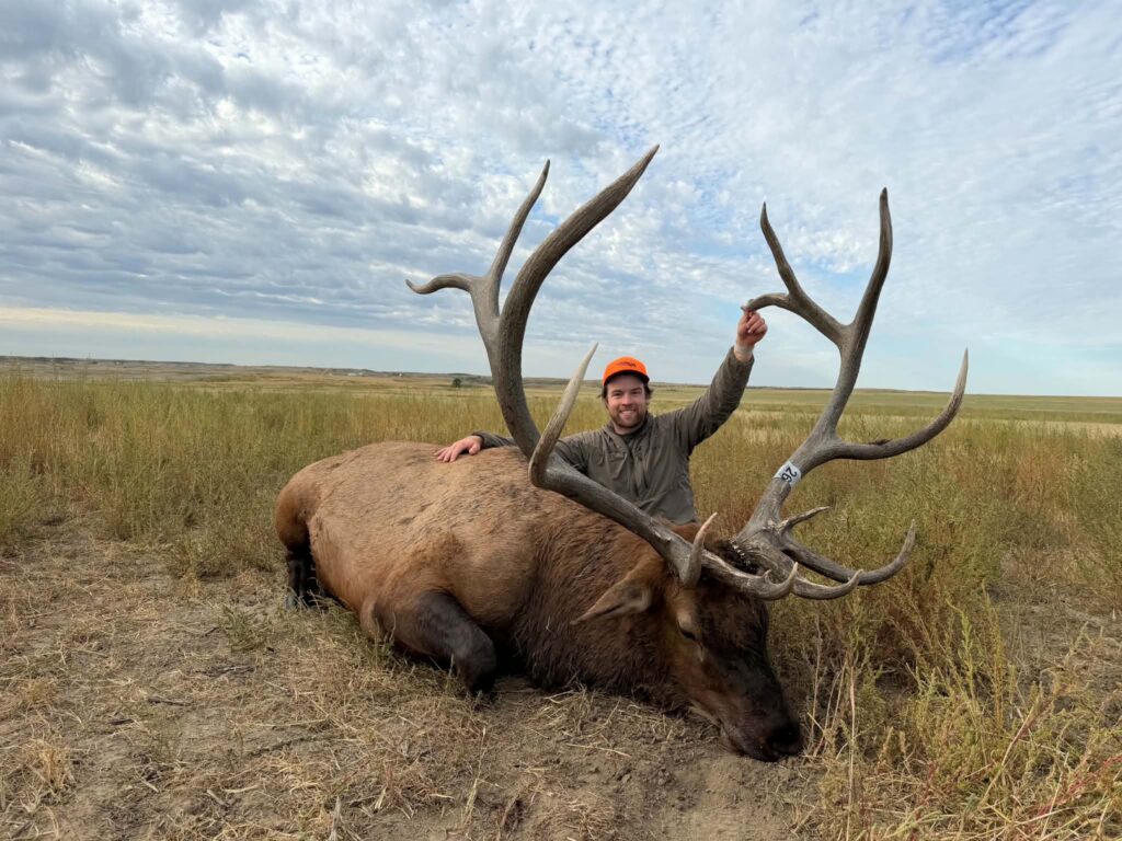 North Dakota Hunter Shoots Giant Bull Elk During Public Land Hunt in the Badlands A North Dakota elk hunter poses with a trophy bull taken in the Badlands.
