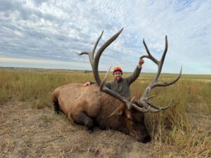 A North Dakota elk hunter poses with a trophy bull taken in the Badlands.