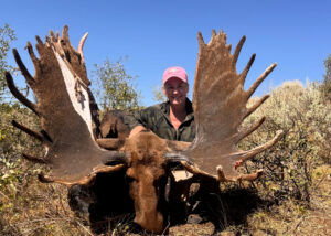A hunter poses with a potential world-record moose.