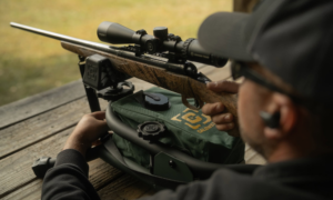 Man shooting rifle on Caldwell Lead Sled shooting rest