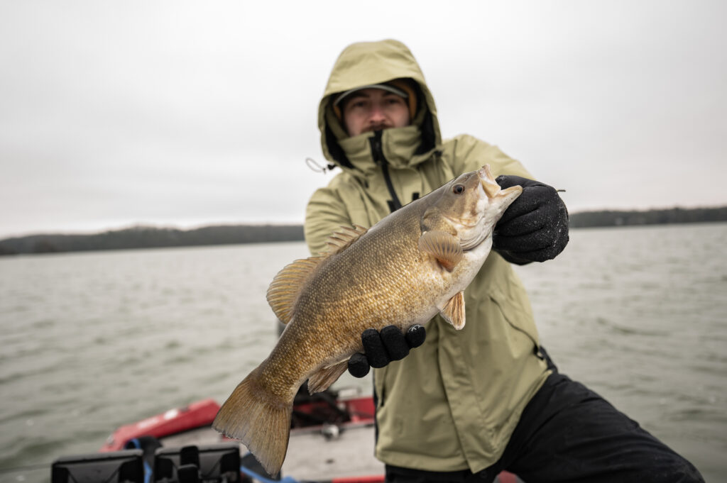 Fall Bass Fishing: Tactics for Autumn Bucketmouths and Bronzebacks Angler holding smallmouth bass