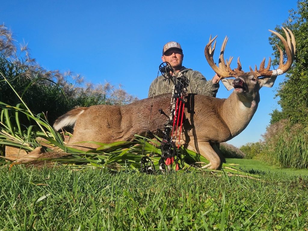 A hunter poses with a trophy whitetail taken in Indiana. 