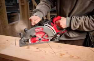 Man cutting wood with Milwaukee cordless saw