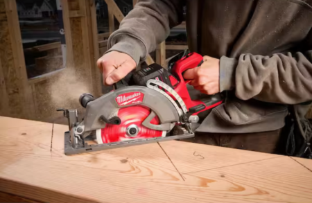 Man cutting wood with Milwaukee cordless saw