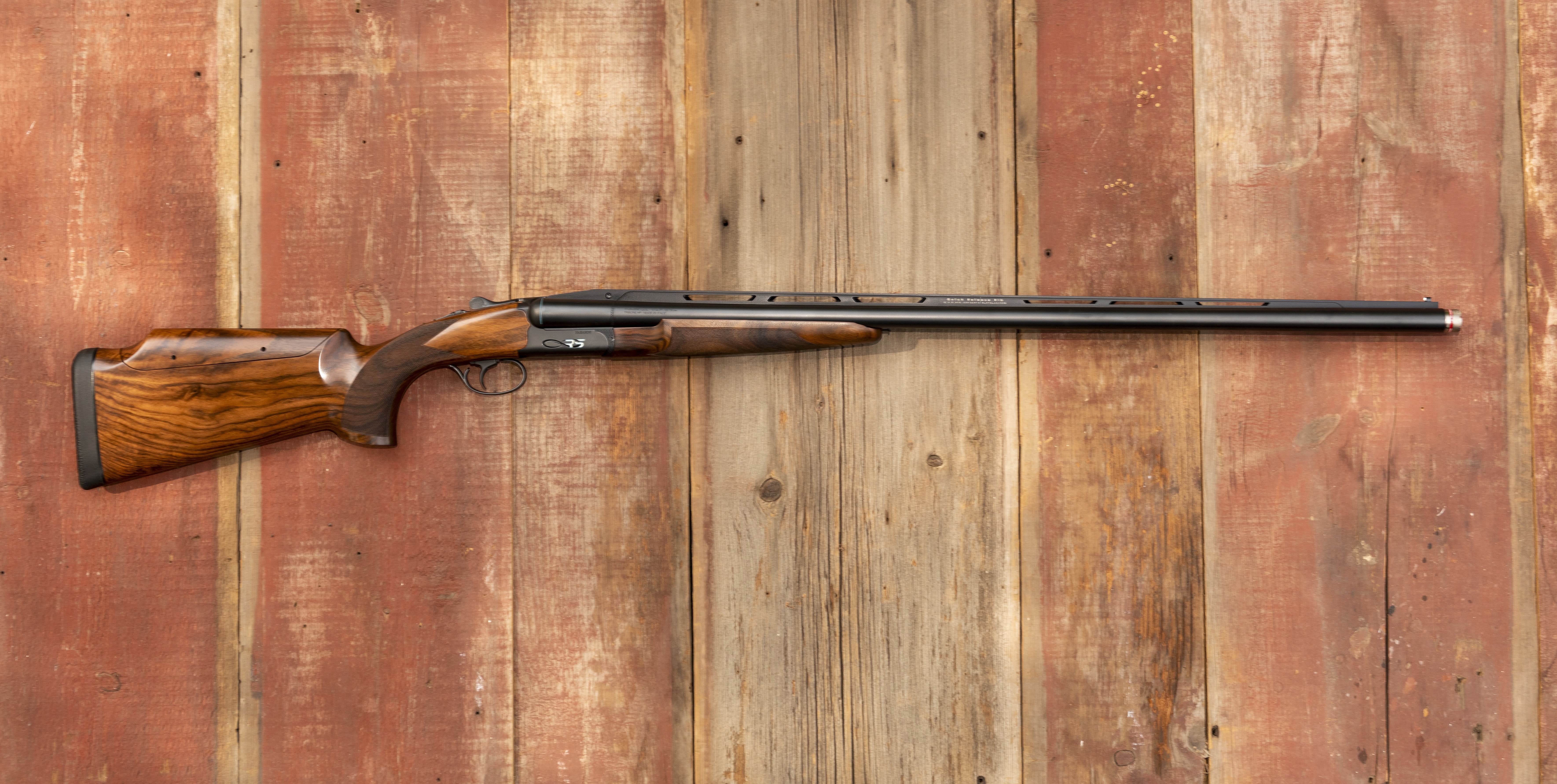 Fabarm Infinite RS shotgun on a barn-board background. 
