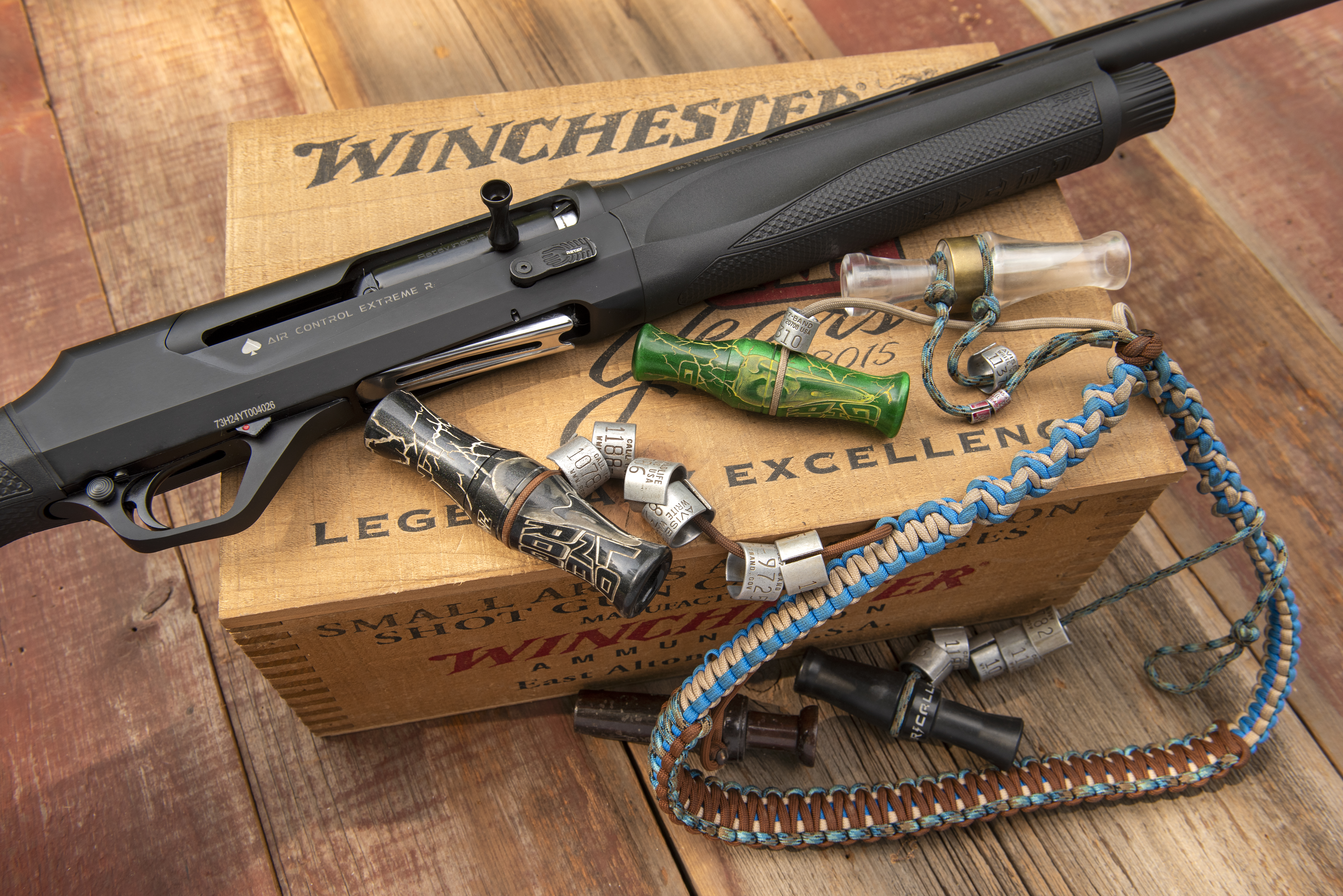 A closeup look at the new Retay ACE-R shotguns action, resting on a Winchester box with duck calls.