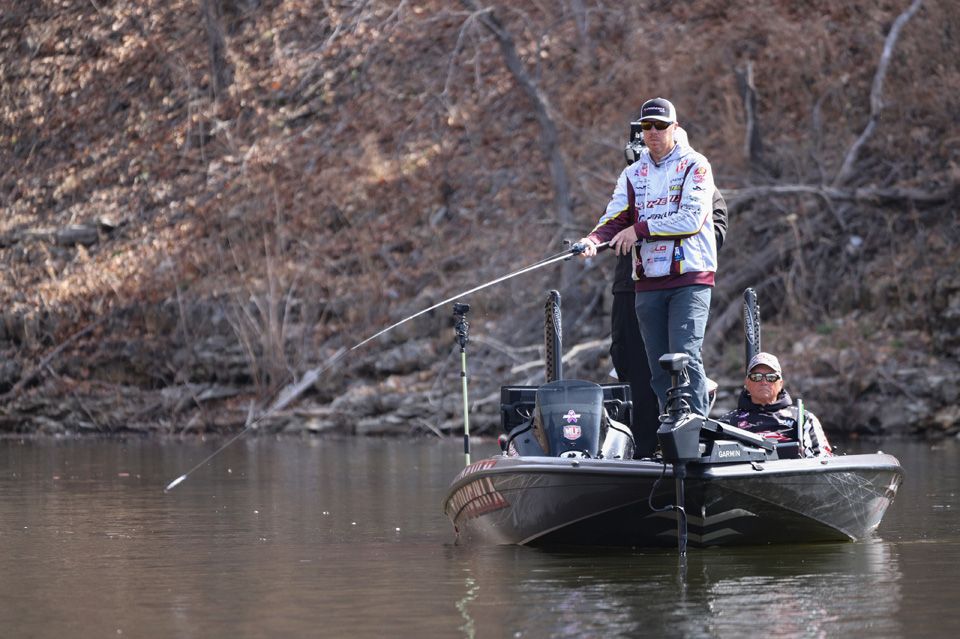 Angler making a cast on bass boat