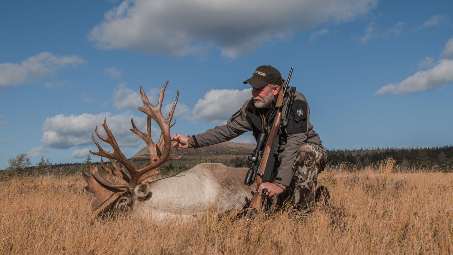 A hunter poses with a caribou bull. 