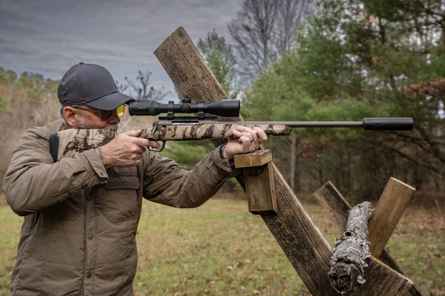 A shooter fires the new Savage Axis 2 pro rifle from a barricade. 