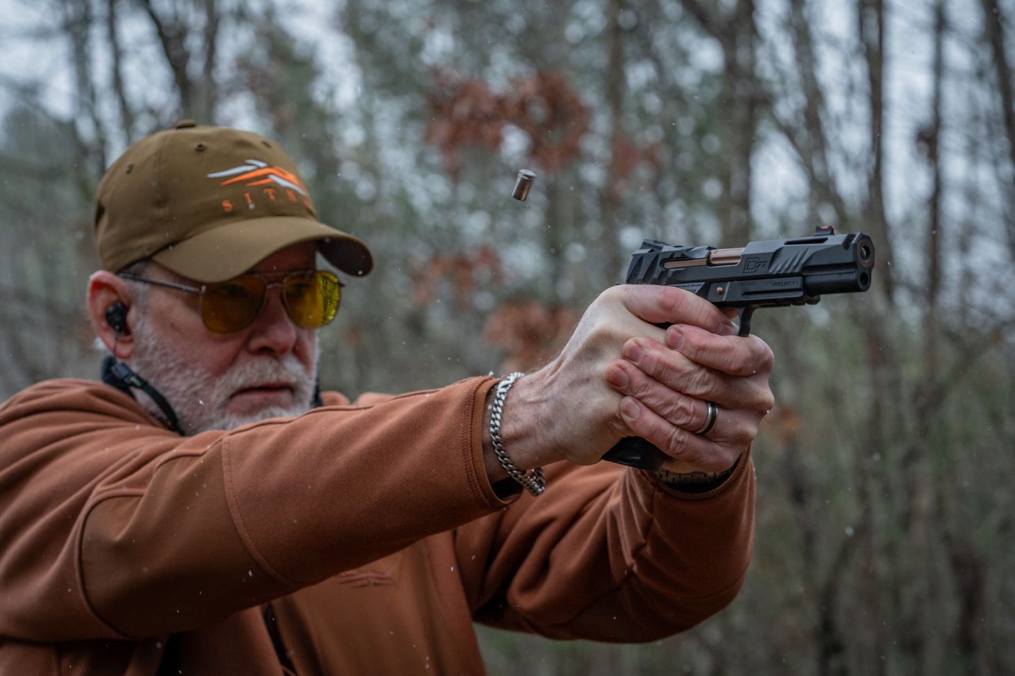 A marksman aims a 40 S&W handgun.