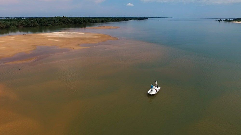 a drone image of a small boat on the upper parana river