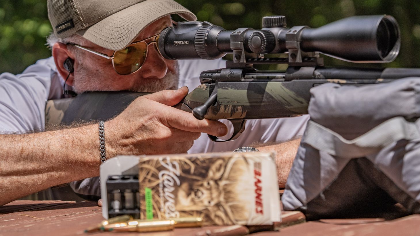 A shooter fires the new Weatherby Vanguard Black Hills rifle from a bench rest. 