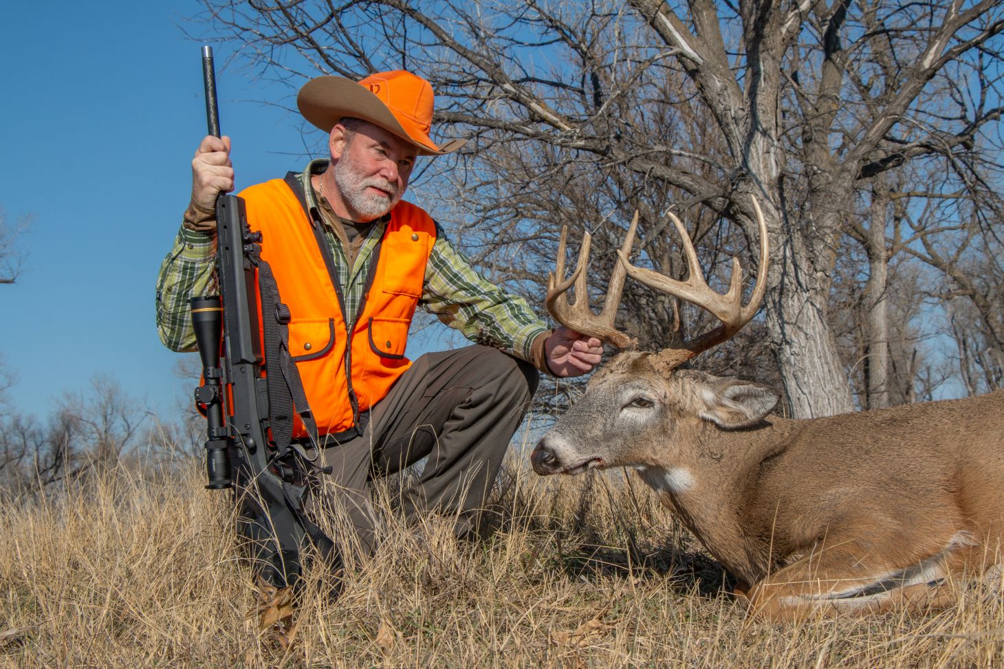 A hunter with a whitetail buck.  