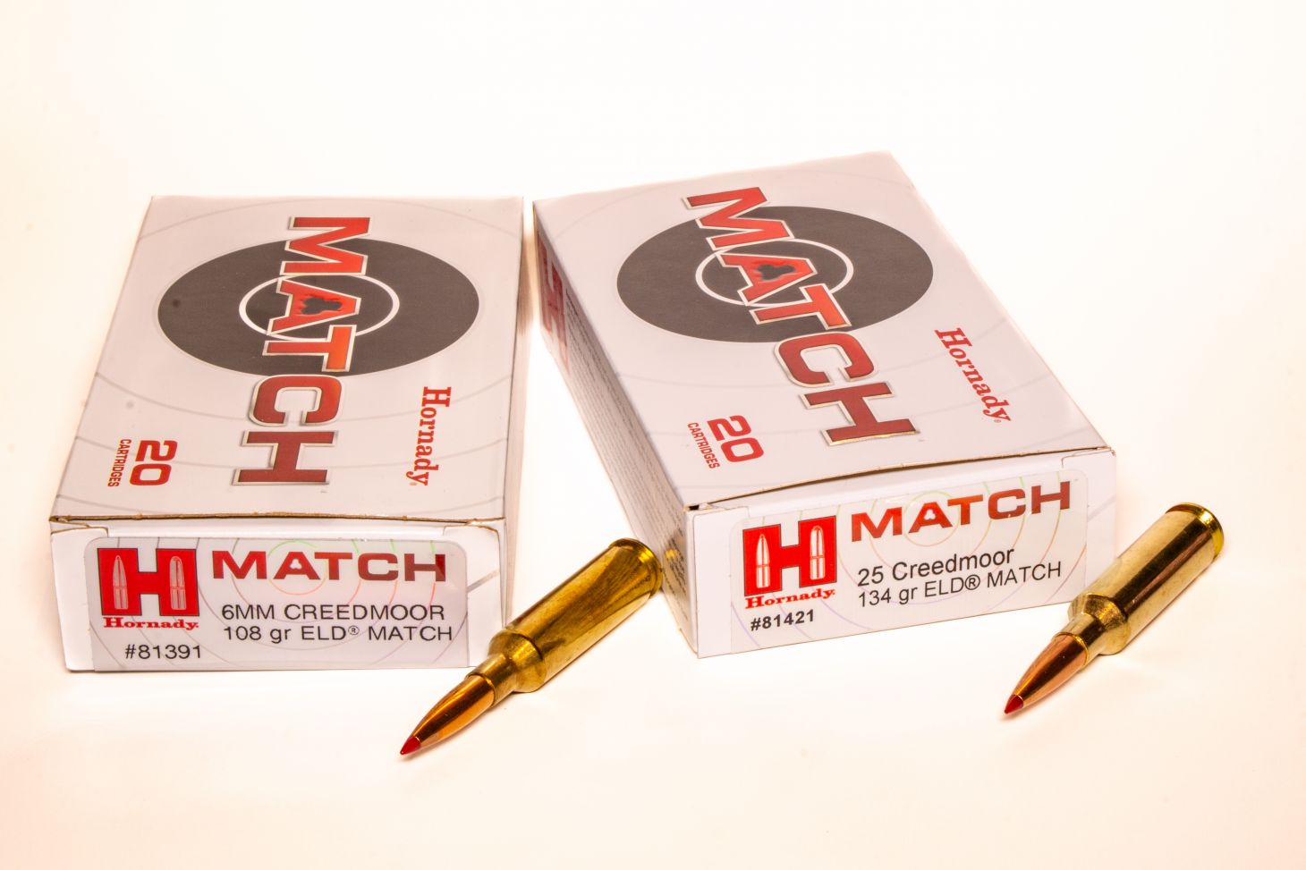 6mm Creedmoor vs 25 Creedmoor ammo on a white background. 