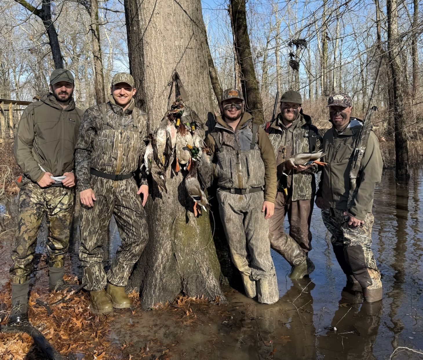 Duck hunters pose with a strap of mallard in Arkansa's flooded timber.