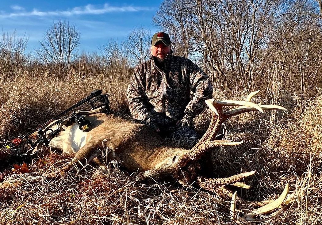 Well-known hunter Adam Hays III poses with a huge whitetail buck. 