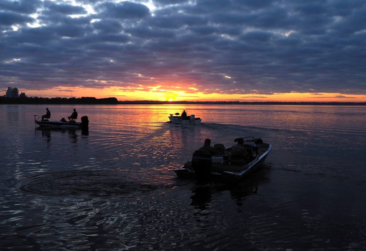 Fisherman heading out to their favorite fishing sites at sunrise on a Florida lake.