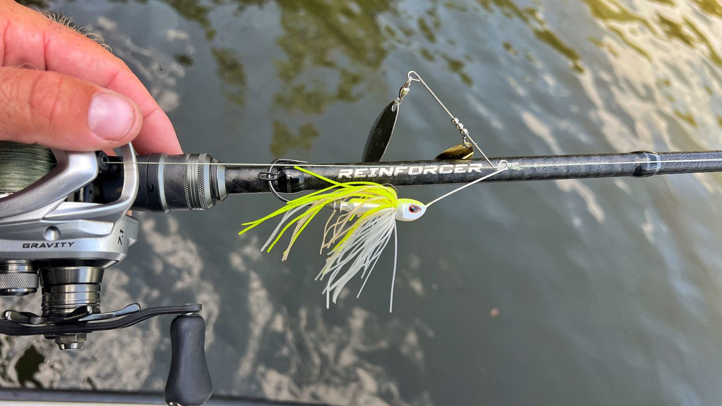 Angler holding Ark Reinforcer baitcasting rod