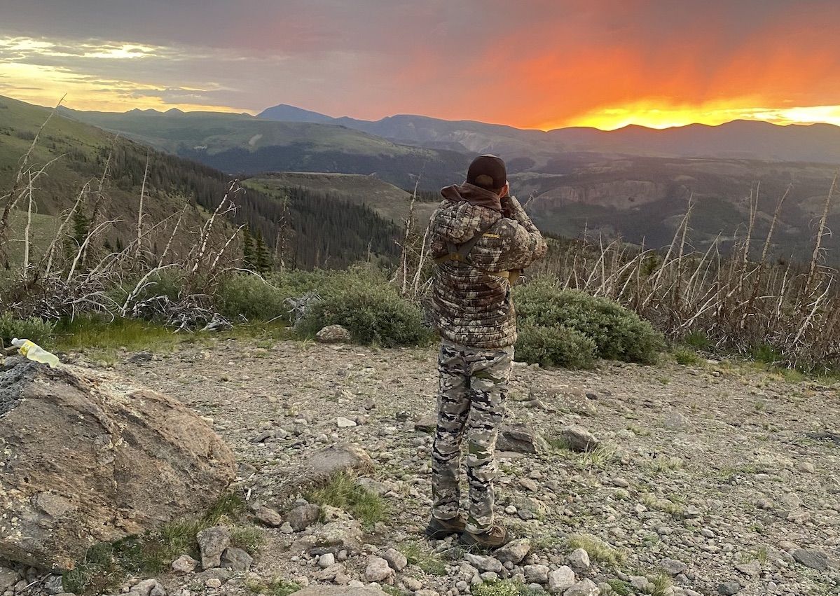 Hunter glassing mountains in the west