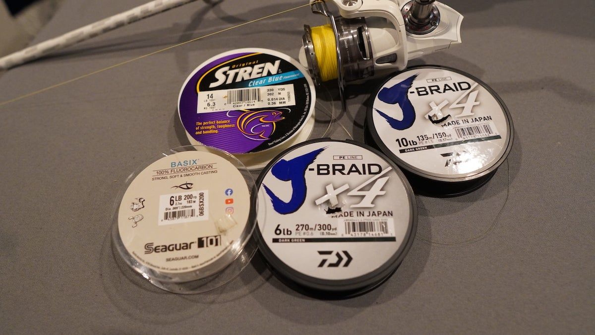 Spools of the best fishing line for bass sitting on table during testing