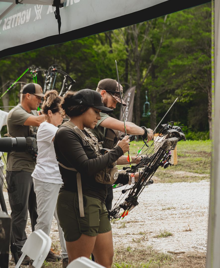 Woman shooting Bowtech Eva Gen 3 compound bow at the Bowtech Rally event