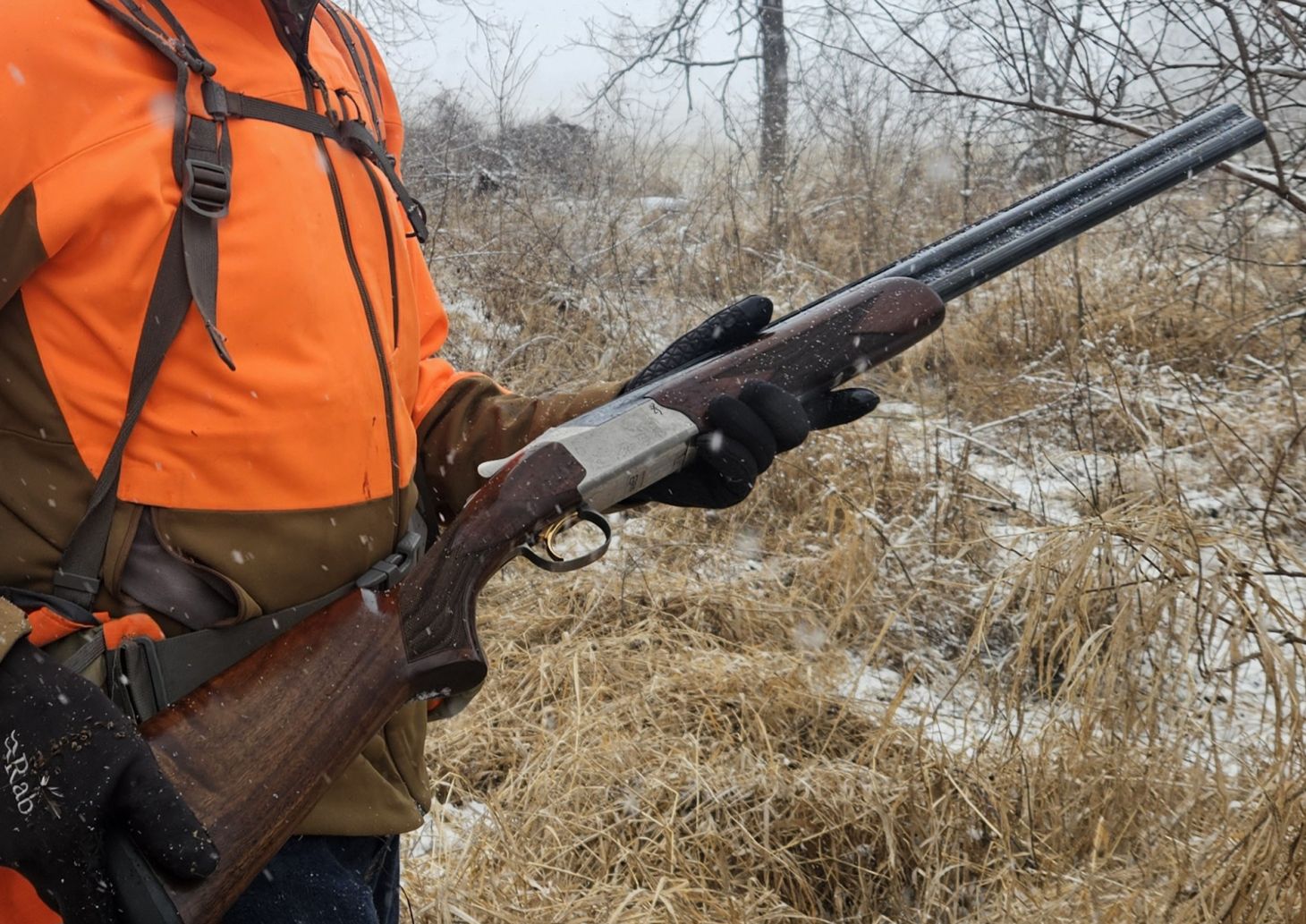 A hunter holds the new Browning 825 shotgun on a late season hunt in the snow.