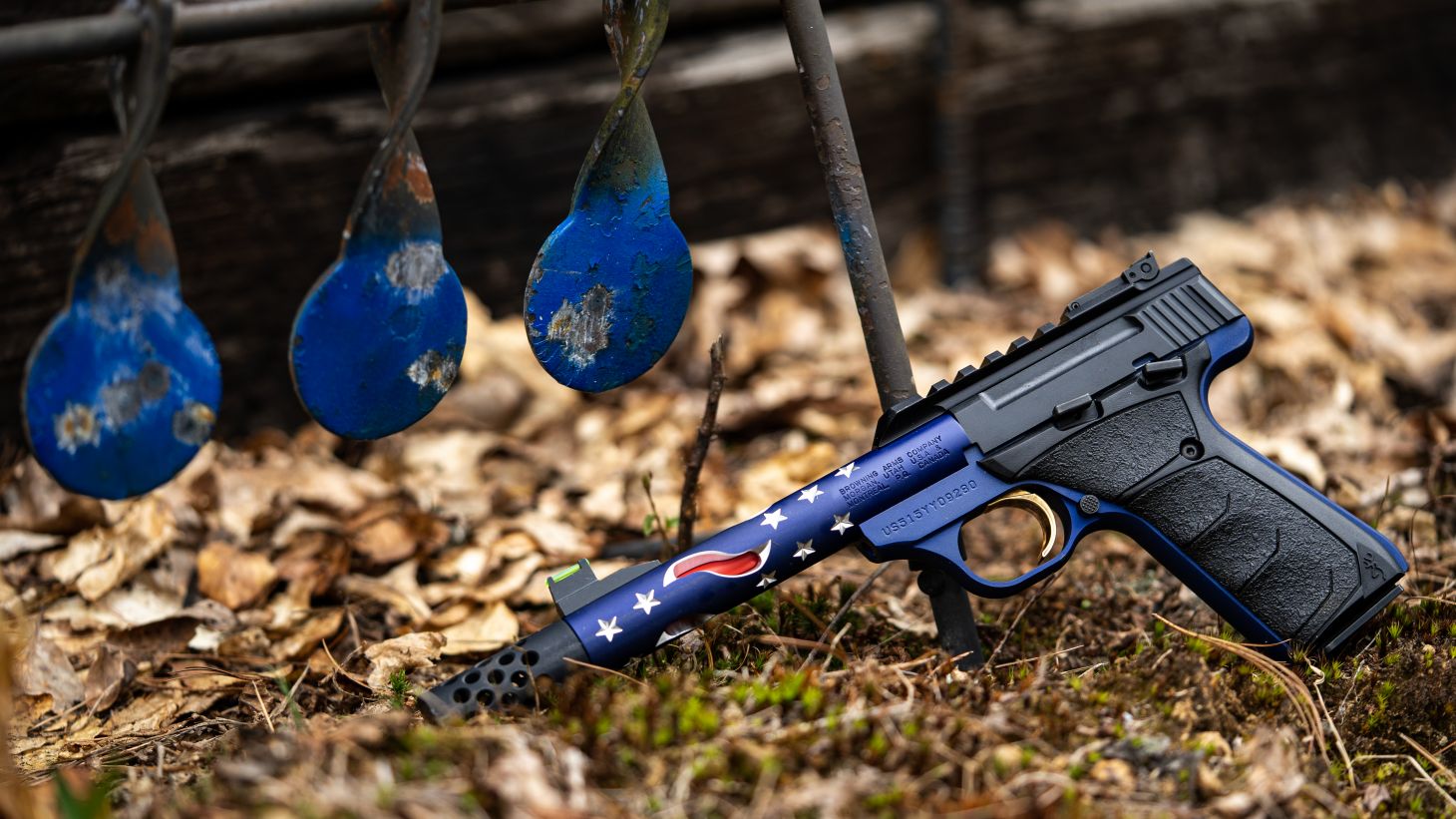 Browning Buck Mark Plus Vision Americana Suppressor Ready 22 LR pisol laying on ground