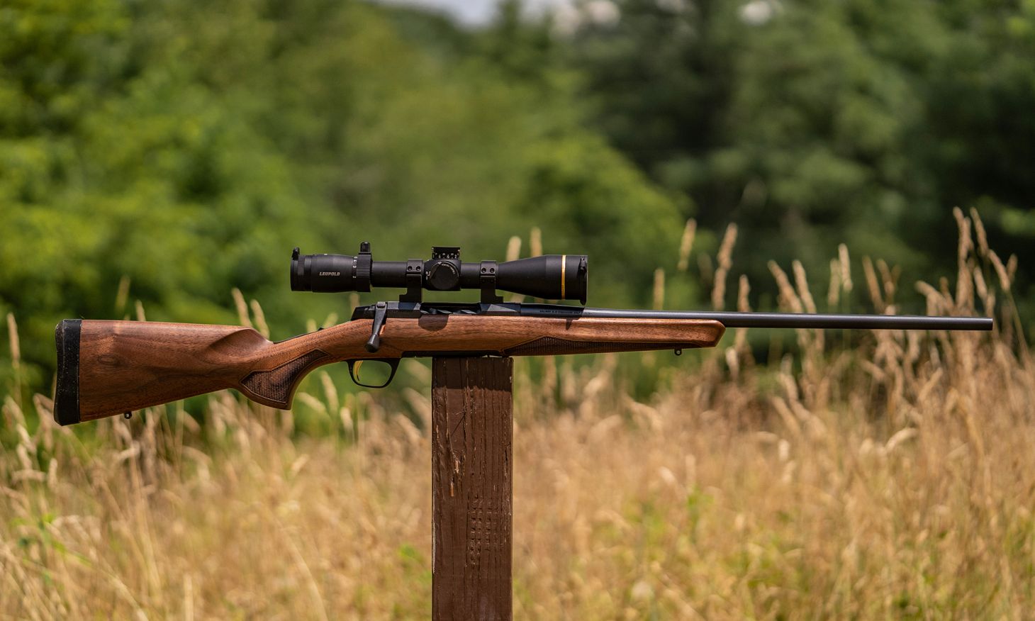 The new Browning X-Bolt 2 Hunter rifle balanced on a post in a field. 