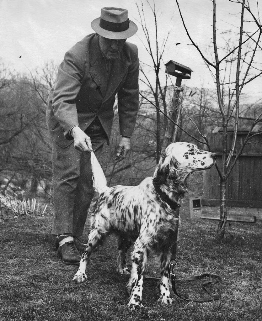 black and white photo of earl twombly and hunting dog