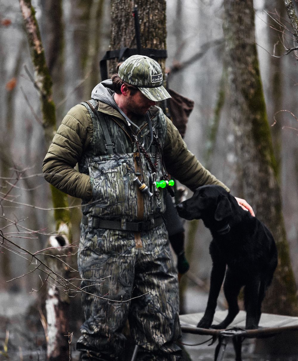 Duck hunter wearing Chene Gear Waders with dog