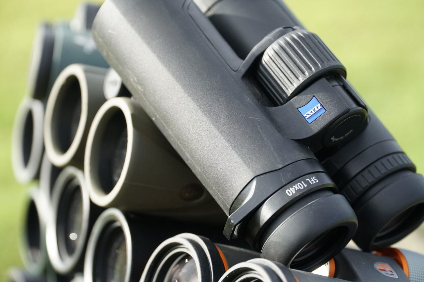 Zeiss SFL 10x40 binocular resting on a stack of other binoculars.