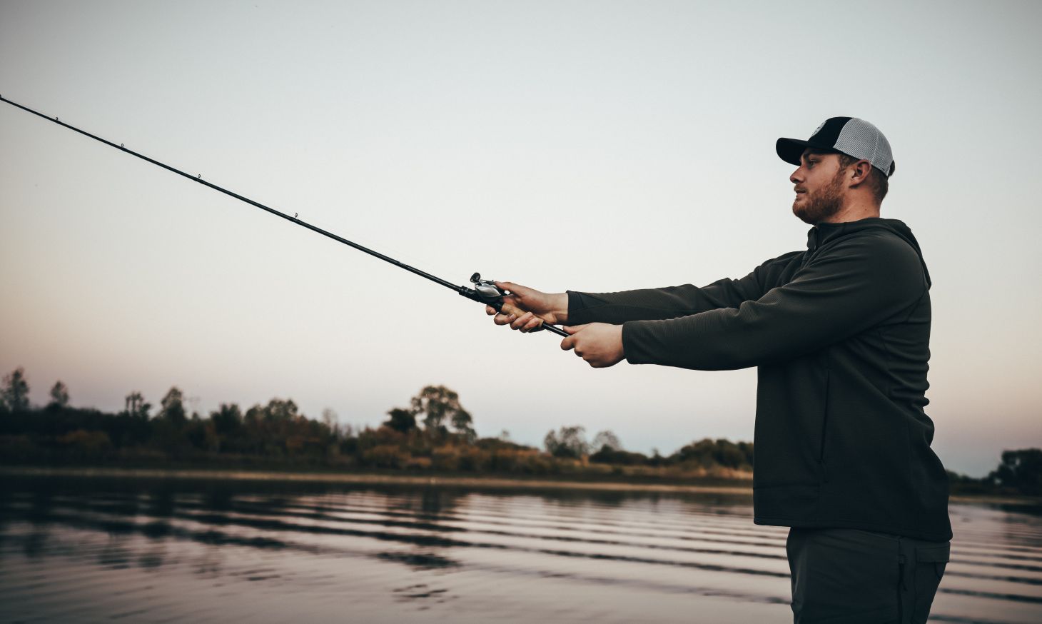 Angler making a cast with Okuma X-Series rod