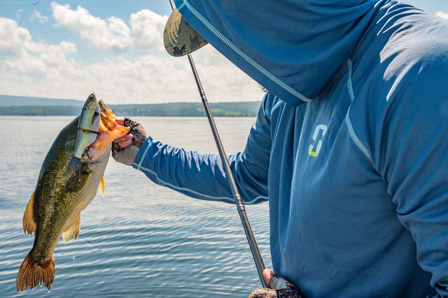 Angler holds bass with glide bait