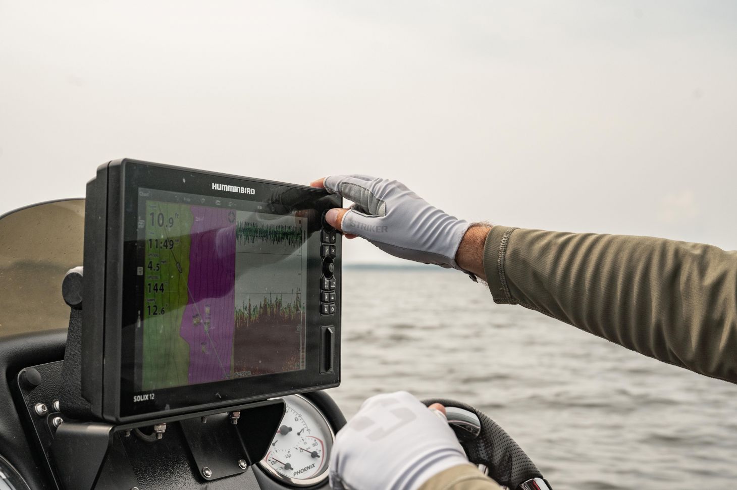 Angler using touch screen on boat