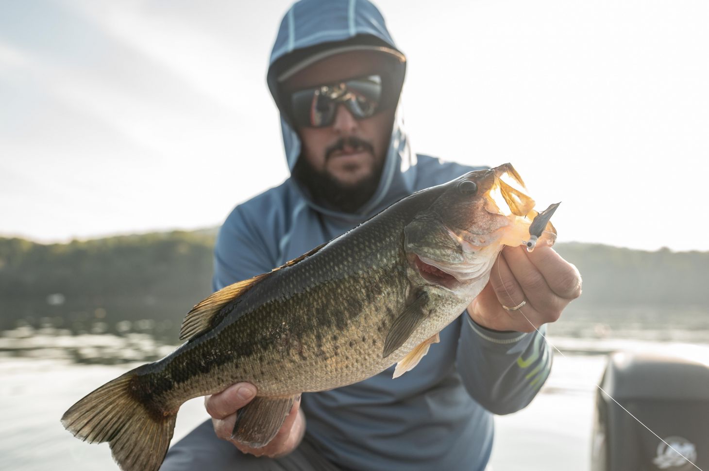 Angler holding up largemouth bass
