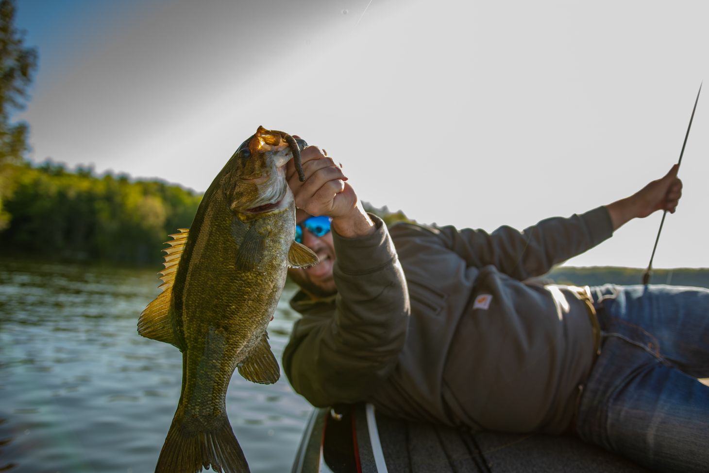 Angler holding up smallmouth bass