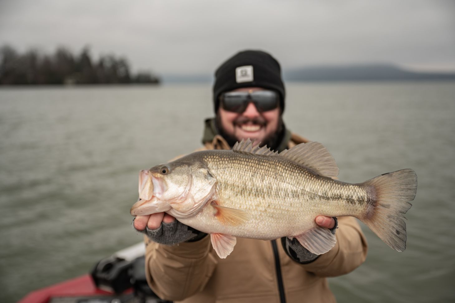 Angler holding up largemouth bass