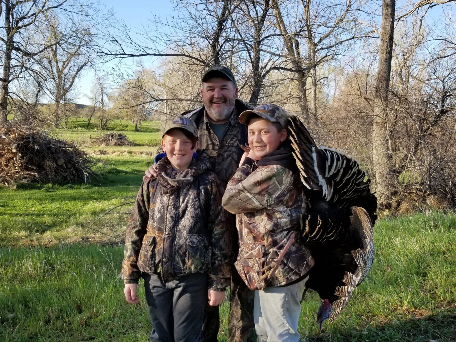 Turkey expert Dave Ciani shows off a tom turkey with his grandsons.
