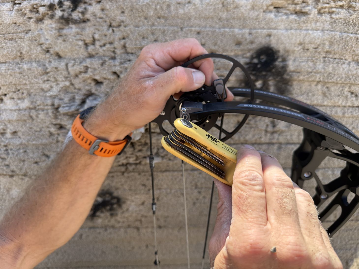 An archer adjusts the DeadLock tuning system on a Bowtech Proven 34 bow. 
