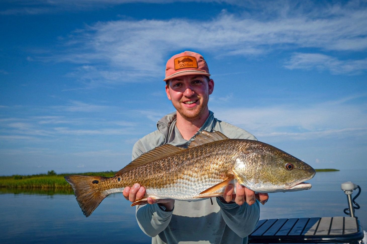 Angler holding redfish