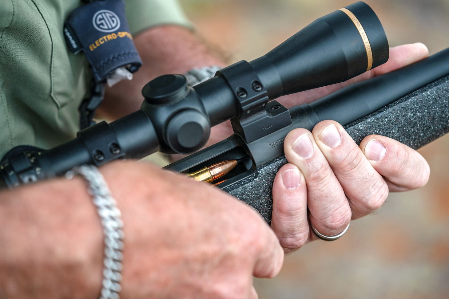 Shooter loads a round into the magazine of a Wilson Combat NULA Model 20 bolt-action rifle. 