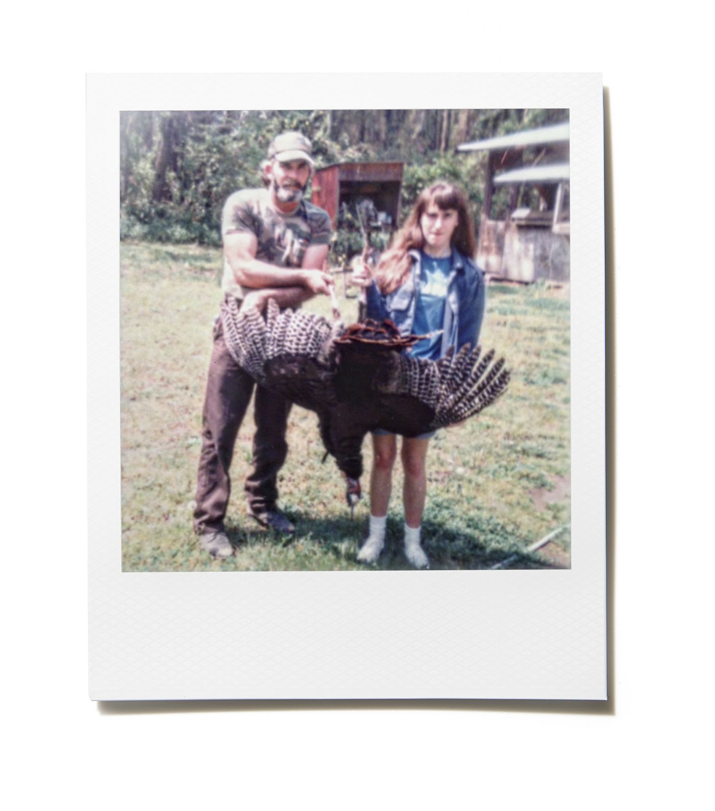 a girl and her dad hold a turkey