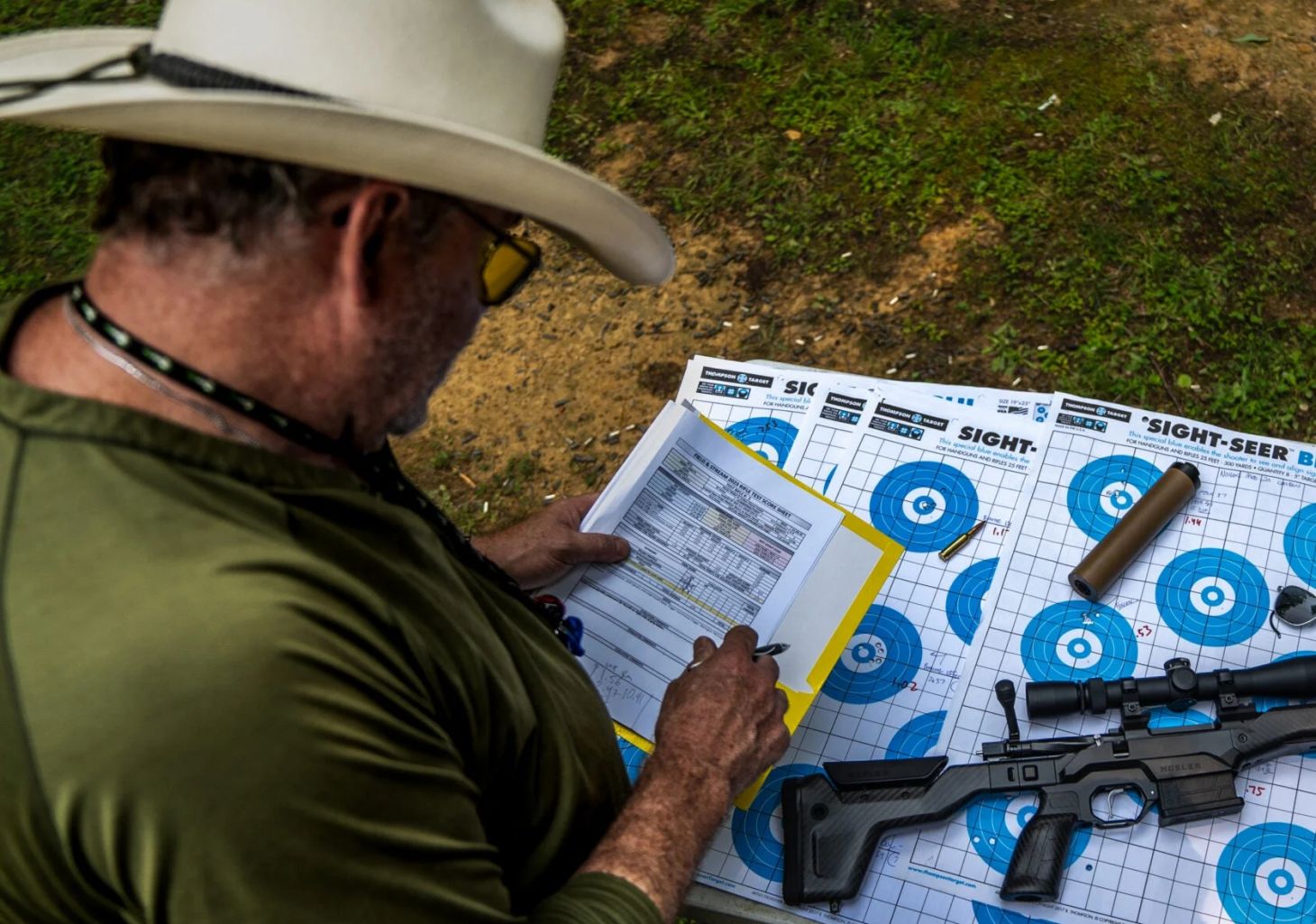 A shooter studies at an array of rifle targets. 