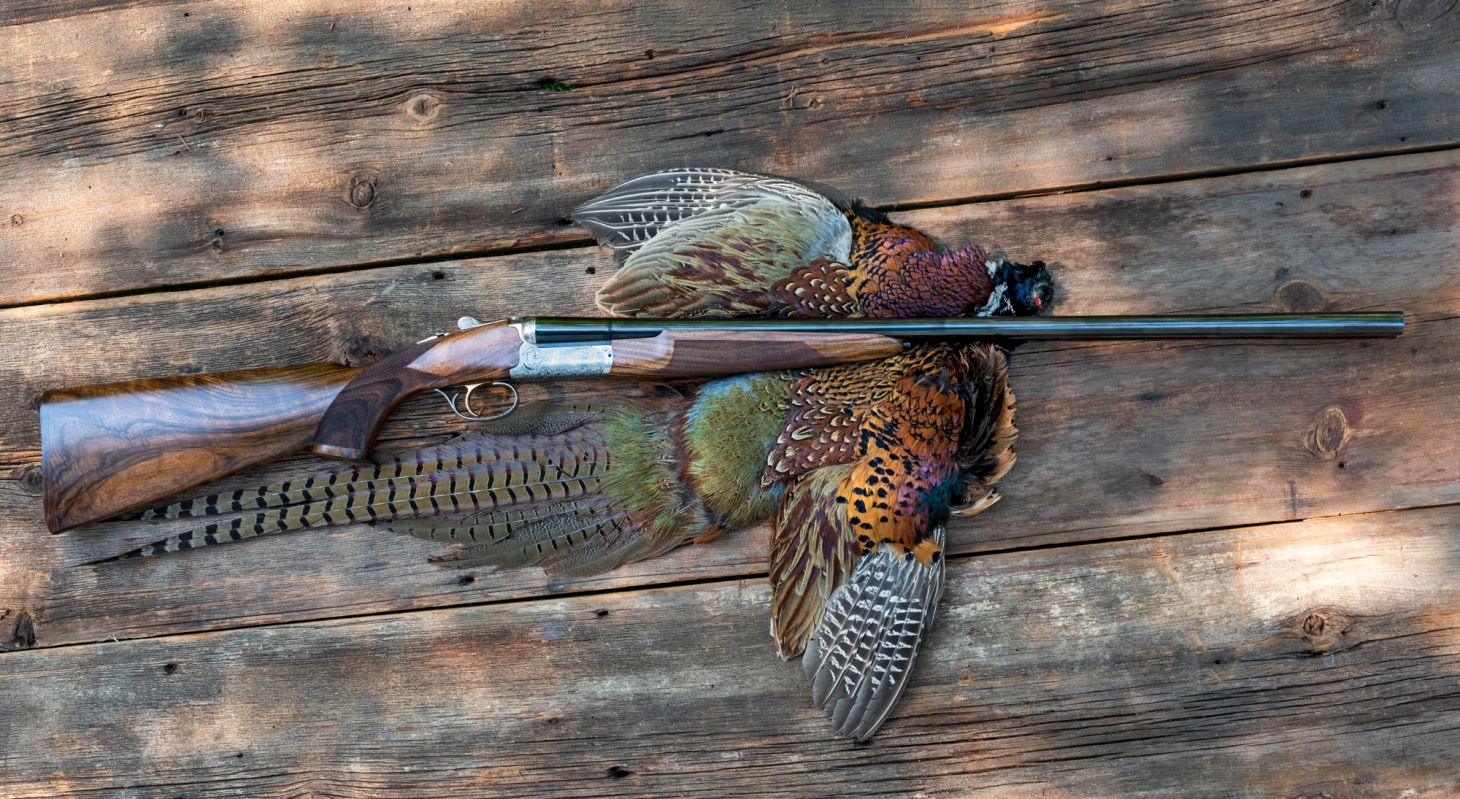 Fabarm Autumn Elite side-by-side shotgun on a pheasant pelt. 