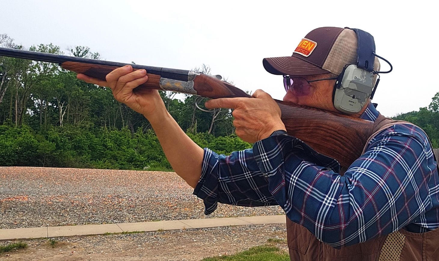 A shooter fires the Fabarm Autumn Elite shotgun on a skeet range. 