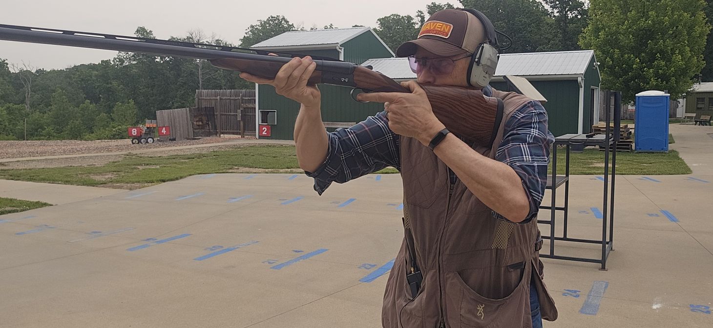 A shooter fires the new Fabarm Infinite RS side-by-side shotgun on a skeet range. 