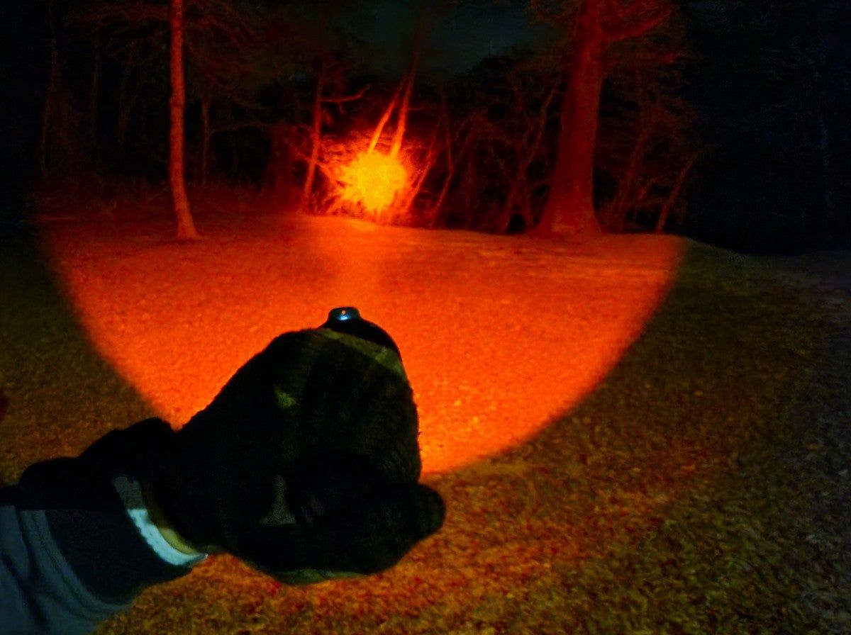 Red beam of Fenix HT18R Long-Distance Flashlight at night
