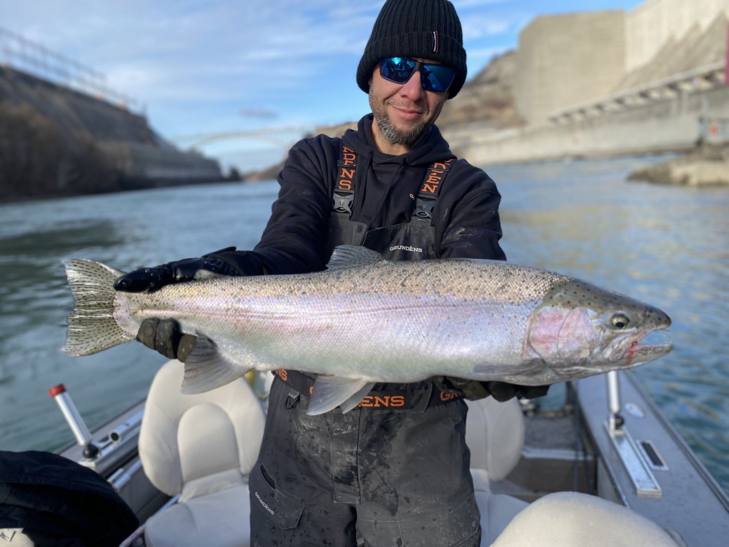 Angler holding up up steelhead