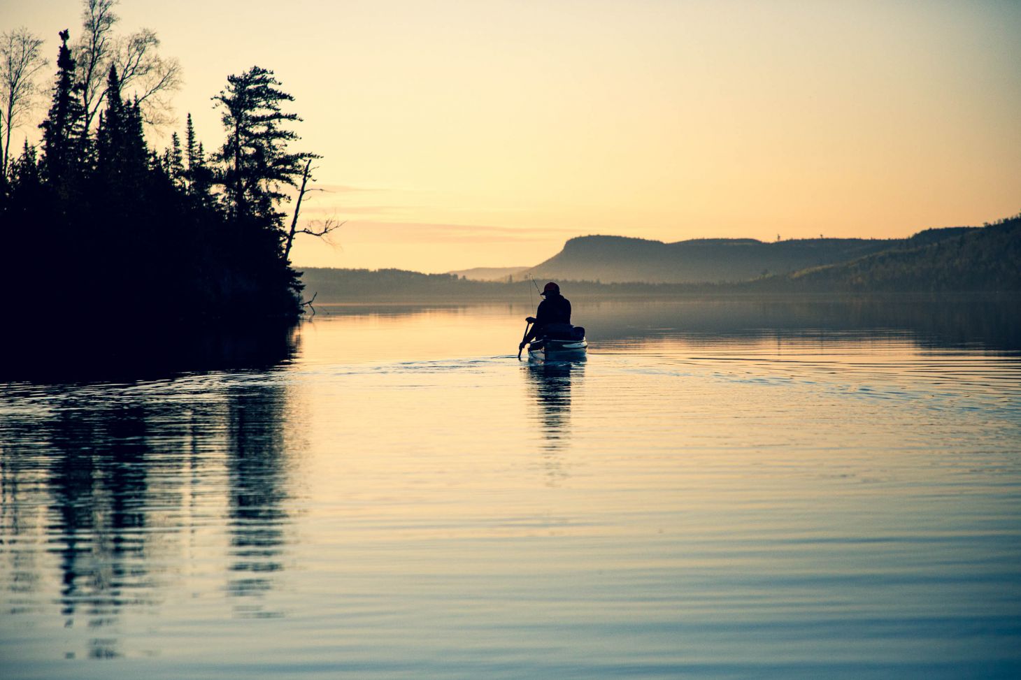 Canoeists paddle at sunset in the Boundary Waters Canoe Area Wilderness in northern Minnesota. 