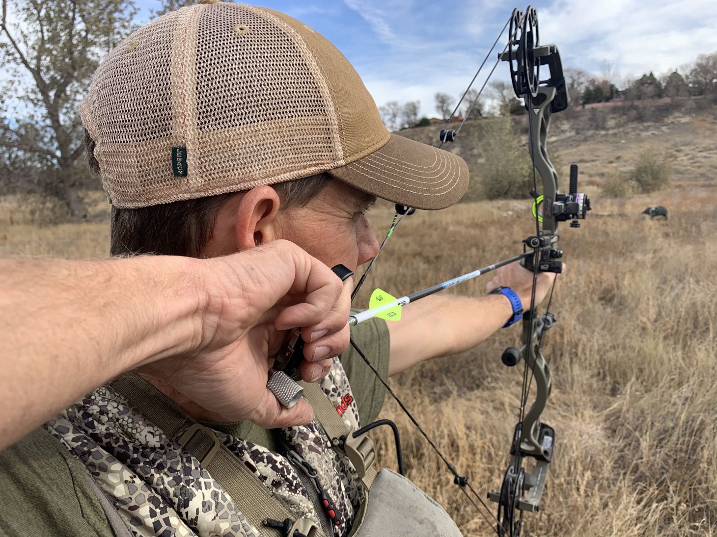 A bowhunter shoots at a 3D pig target. 